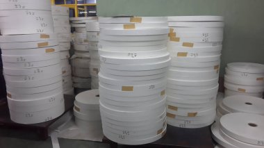 Kolkata, West Bengal, India - 6th May 2021 : White Paper Reels are stacked up before being used as bottom of Paper cups. Indian paper cup making industry is growing.