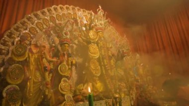 Howrah, India- October 15th, 2021 : Holy smoke is covering Goddess Durga idol on Sandhi Puja, the sacred juncture of Ashtami, eighth day and Nabami, nineth day, as Hindu ritual for praying to Goddess.