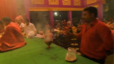 Howrah, India - October 15th, 2021 : Holy smoke is made for Goddess Durga on Sandhi Puja, the sacred juncture of Ashtami, eighth day and Nabami, nineth day, as Hindu ritual for praying to Goddess.