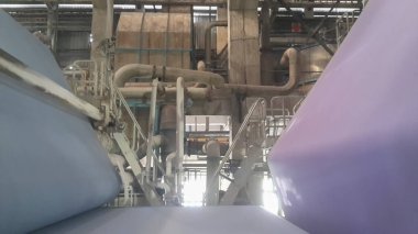 Kolkata, West Bengal, India - 5th May 2021 : White Paper Reels are being manufactured in a paper manufacturing plant. Indian paper industry is growing.