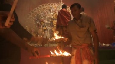 Howrah, India- October 15th, 2021 : Holy 108 lamps are being lit during sondhipujo aarti by Hindu devotees. Goddess Durga is being worshipped at night, juncture of Ashtami and Nabami.