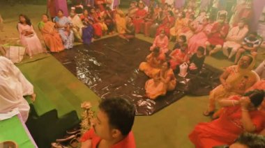 Howrah, India- October 15th, 2021 : Devotees watching Sandhi Puja, the sacred juncture of Ashtami, eighth day and Nabami, nineth day, as Hindu ritual for praying to Goddess Durga. Durga puja festival.