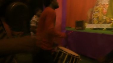 Kolkata, Hindistan -13 Ekim 2021: Dhaakis dhaaks oynarken Hindu rahipler kabuklu veya shankha, chamor ve el vantilatörü ile tanrıça Durga 'ya tapıyorlar. Ashtami puja aarati - kutsal Durga Puja ritüeli.