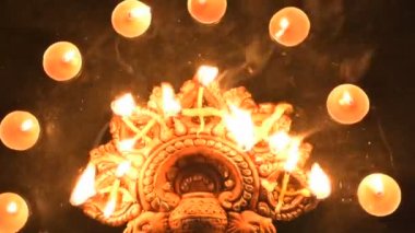 Top view of diwali candles or diya put in circle. Deepawali lights at night. Dark background stock footage.