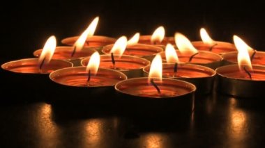 Very low angle view of Diwali diyas or candles. Deepawali lights at night. Dark background stock footage.