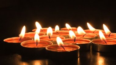 Very low angle view of Diwali diyas or candles. Deepawali lights at night. Dark background stock footage.