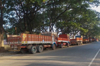 Dandeli, Karnataka, India - 15th May 2019 : Commercial trucks lined up before loading materials. Morning scene at Dandeli.