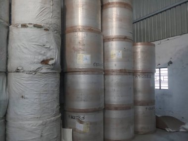 Kolkata, West Bengal, India - 5th May 2021 : White Paper Reels are stacked up after manufacturing in a paper manufacturing plant. Indian paper industry is growing.