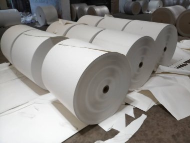Kolkata, West Bengal, India - 16th May 2019 : Manufactured white Paper Reels are being finished with wrappers on them, in a big paper manufacturing plant. Indian paper industry is growing.