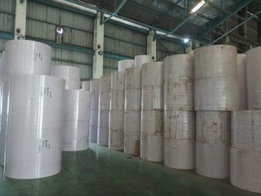 Kolkata, West Bengal, India - 5th May 2021 : White Paper Reels are stacked up after manufacturing in a paper manufacturing plant. Indian paper industry is growing.