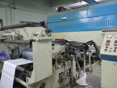 Kolkata, West Bengal, India - 16th May 2019 : State of the art modern machineries PE coating cup stock white Papers in a big Cup paper coating plant. Plastic ban increases use of paper cups.
