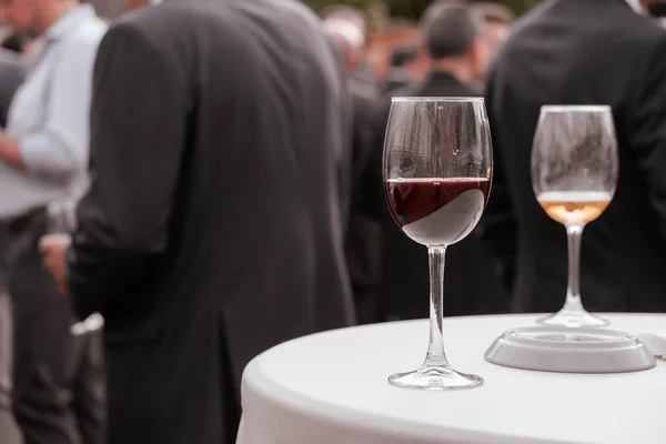 A glass of wine on a catering table. Outdoor events, gatherings of friends, work events.
