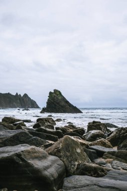 Aguilar beach at low tide, one of the most beautiful beaches in Asturias, in the municipality Muros del Nalon, Spain. Vertical photo