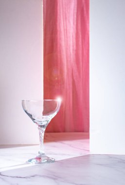 illuminated cocktail glass, with pink fabric background. luxury concept