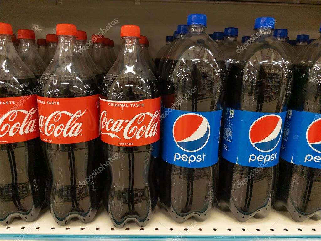 Plastic bottles of Coca Cola and Pepsi kept together on the shelf of a supermarket at Pune, India on 30 August 2021