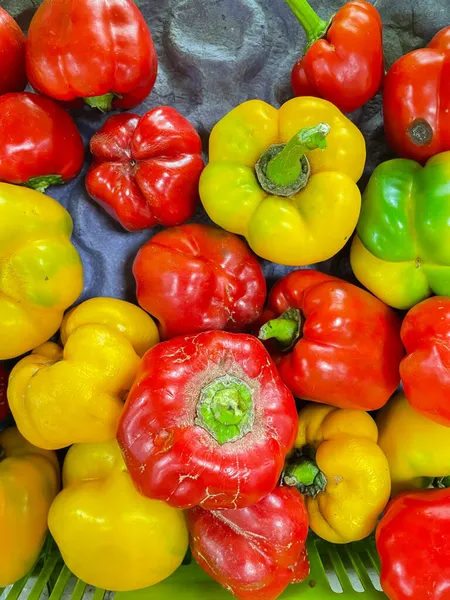 Raw Red yellow and green peppers also called capsicum kept in a market stall