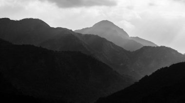 Panoramic view of Silhouette of mountains and mountain peaks with in black and white  