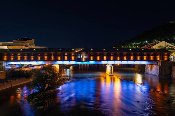 The colorful covered bridge in Lovech, Bulgaria at night. The bridge is built over the Osam river.