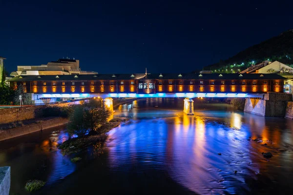 The colorful covered bridge in Lovech, Bulgaria at night. The bridge is built over the Osam river.