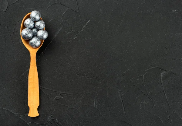 Wooden Spoon Candy Hazelnuts Chocolate Dark Concrete Background Copy Space — Stockfoto
