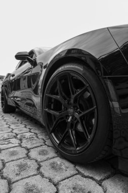close-up of a sports car tire on the street, modern car racing design, elegant lifestyle, speed and luxury