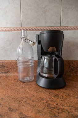 details of a coffee pot next to a glass jug, objects and kitchen machine, modern utensil with style