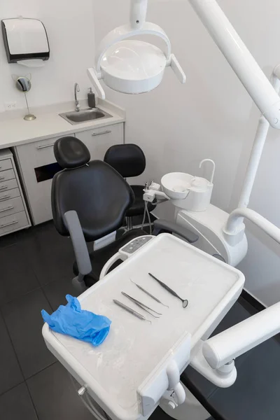 dental office interior equipped with dental chair, lamp and tools, professional objects in workplace, medicine