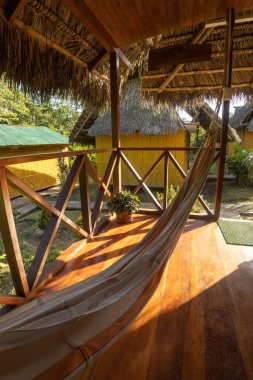 space designed to relax in a hotel with a hammock and sunbeams, wooden decoration, cozy destination with wooden decoration, lifestyle