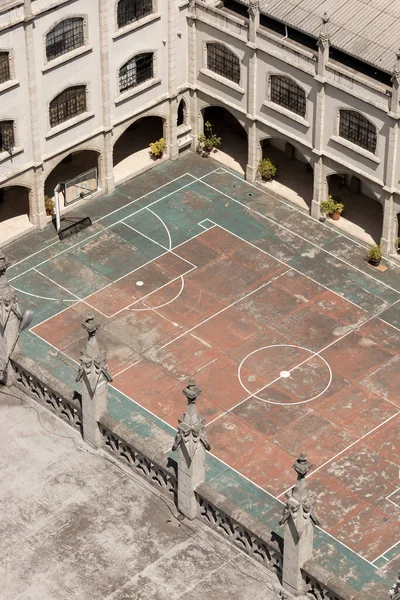 basketball and soccer fields inside a school, classical architecture and decoration, scene without people