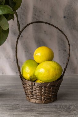 beautiful centerpiece with a wicker basket and some fresh passion fruit, fruits as decoration in the studio, texture detail