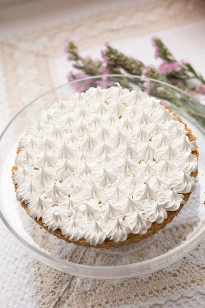 delicious cake decorated with pastry cream, next to a natural flower, sweet food wallpaper, homemade appetizing desserts