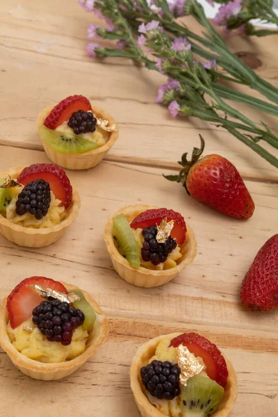 sweet appetizers decorated with fruits and cream, catering service, studio with fresh and delicious food, wallpaper
