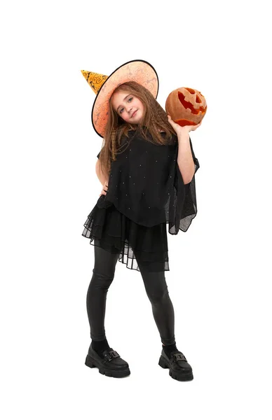 Joyful girl in witch costume holds pumpkin — Stock Photo, Image