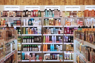 Showcase with cosmetic products for hair care. Shelves with goods in the store 
