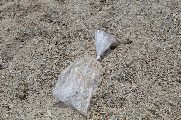 One plastic trash on the sand beach