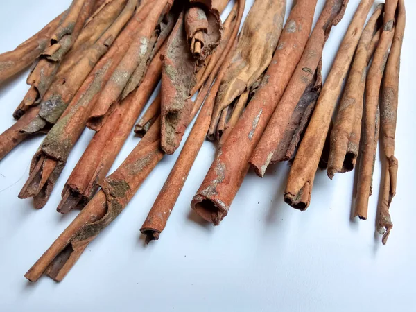 Cinnamomum cassia. Heap of dried and crushed cinnamon sticks, with left-over outer bark, or unfinished shaving.
