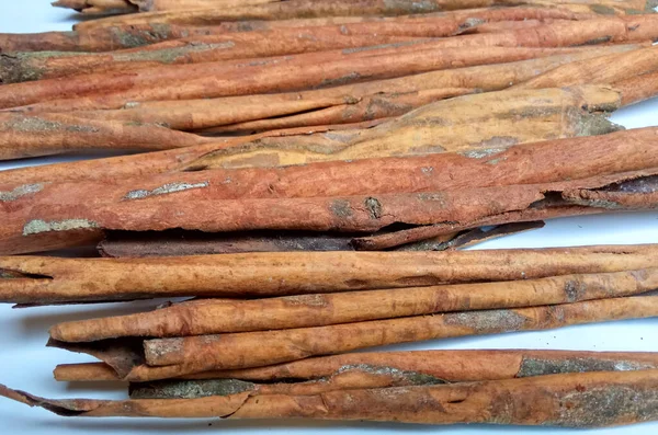 Cinnamomum cassia. Heap of dried and crushed cinnamon sticks, with left-over outer bark, or unfinished shaving.