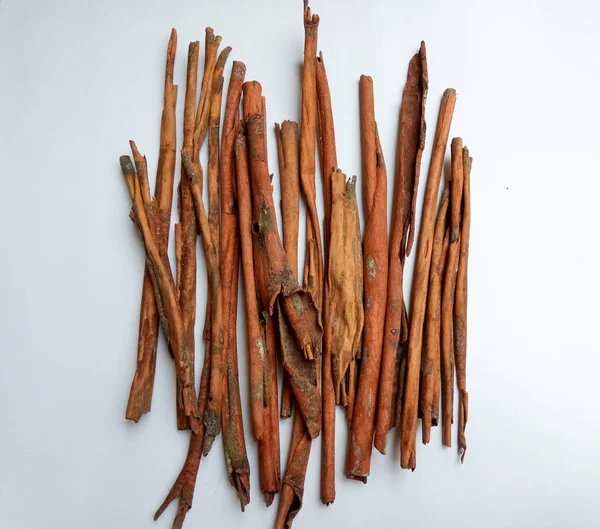 Cinnamomum cassia. Heap of dried and crushed cinnamon sticks, with left-over outer bark, or unfinished shaving.