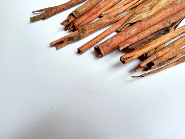 Cinnamomum cassia. Heap of dried and crushed cinnamon sticks, with left-over outer bark, or unfinished shaving.