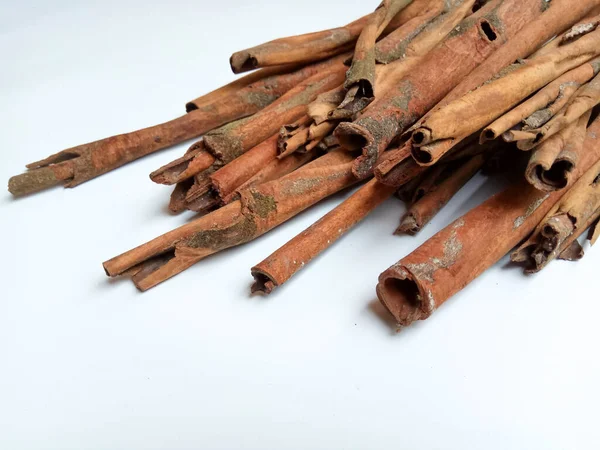 Cinnamomum cassia. Heap of dried and crushed cinnamon sticks, with left-over outer bark, or unfinished shaving.