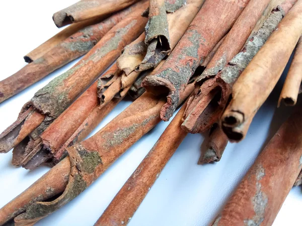 Cinnamomum cassia. Heap of dried and crushed cinnamon sticks, with left-over outer bark, or unfinished shaving.