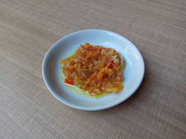 Sambal matang ya da Endonezya 'dan geleneksel acı biber sosu, kabaca sıcak yağla ezilip pişirilmiş. Beyaz küçük bir tabağa yerleştirilmiş..