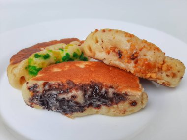 Pukis, çeşitli malzemelerle geleneksel Endonezya krepi. Beyaz tabakta. Beyaz arkaplanda izole edilmiş.