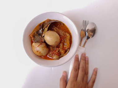 Endonezya yemeği, sambal goreng ati olarak adlandırılır. Tavuk taşlığı, biber, haşlanmış yumurta, hindistan cevizi sütü ve krupuk kulit (inek derisinin yumuşak içi) içerir. Bayram için özel yemek. Seçici odak.