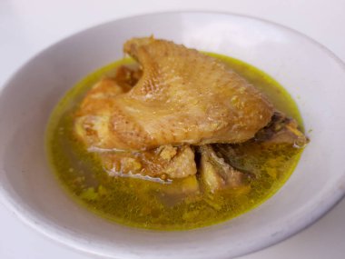 Hindistancevizi sütüyle öğütülmüş tavuk. Opor Ayam adlı Endonezya yemeği. Bayram için imza tabağı getirdim. Beyaz arkaplanda izole edilmiş.