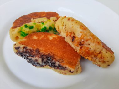 Pukis, çeşitli malzemelerle geleneksel Endonezya krepi. Beyaz tabakta. Beyaz arkaplanda izole edilmiş.