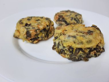 Rolade Daun Singkong, Endonezya 'dan kızarmış bir yemektir. Cassava yaprakları, tofu ve undan yapılmış. Beyaz arkaplanda izole edilmiş.