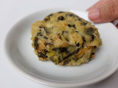 Rolade Daun Singkong, Endonezya 'dan kızarmış bir yemektir. Cassava yaprakları, tofu ve undan yapılmış. Beyaz arkaplanda izole edilmiş.