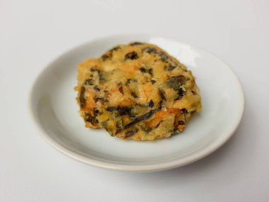 Rolade Daun Singkong, Endonezya 'dan kızarmış bir yemektir. Cassava yaprakları, tofu ve undan yapılmış. Beyaz arkaplanda izole edilmiş.