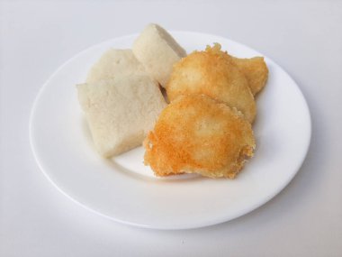 Jadah ketan, Endonezya 'dan geleneksel bir aperatif. Yapışkan pirinç ve rendelenmiş hindistan cevizinden yapılmış. Kızarmadan önceki ve sonraki karşılaştırma. Beyaz bir plaka üzerinde, beyaz arka planda izole edilmiş.